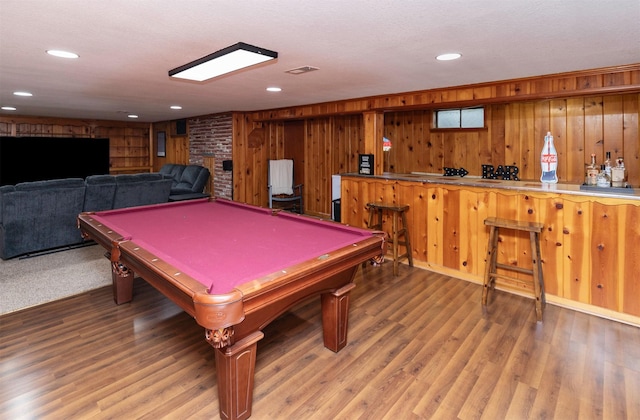 rec room with wood finished floors, wood walls, and pool table