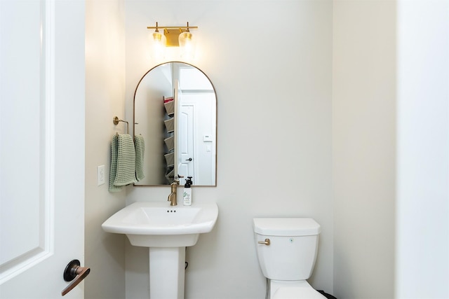 half bathroom featuring toilet