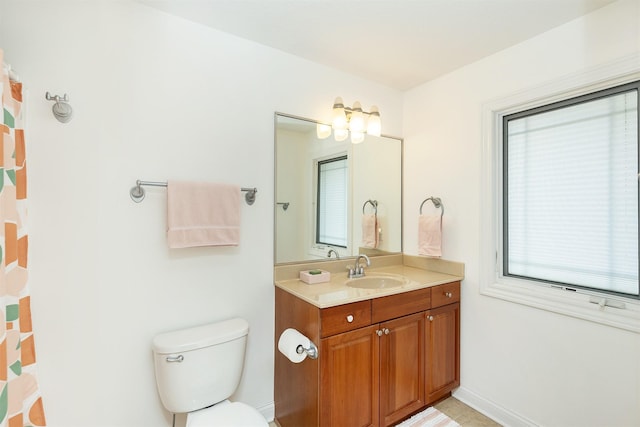 full bath with vanity, baseboards, and toilet