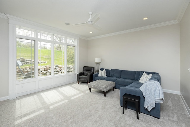 carpeted living area with a ceiling fan, baseboards, recessed lighting, and ornamental molding