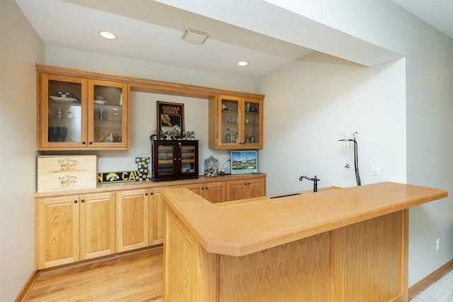 bar with bar, recessed lighting, baseboards, light wood-type flooring, and visible vents