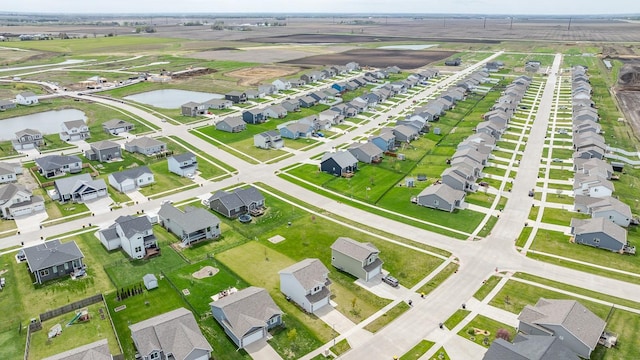 drone / aerial view with a residential view and a water view