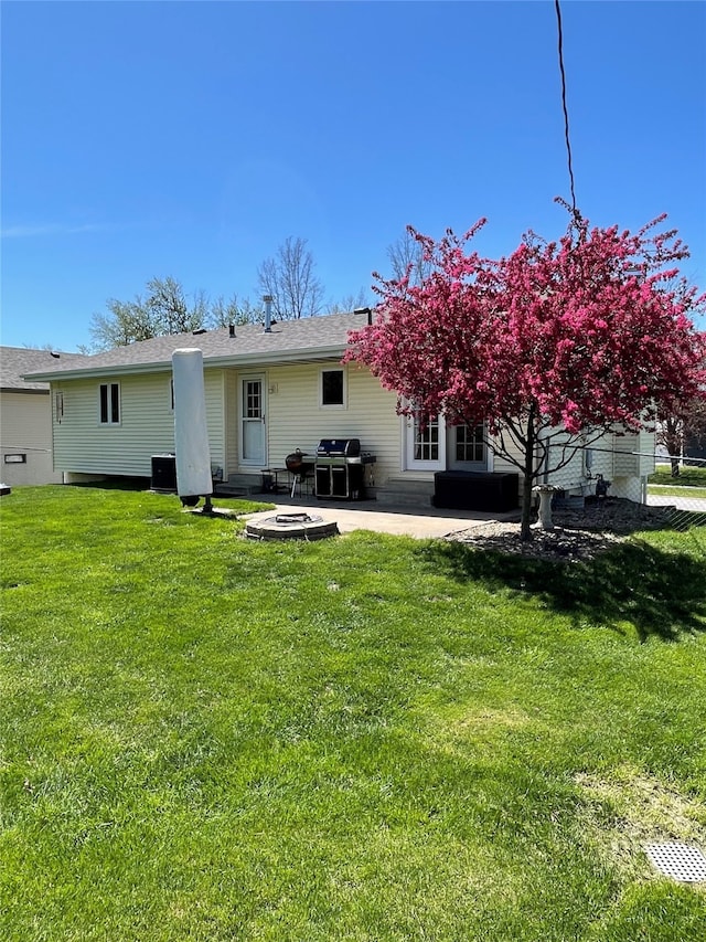 rear view of house featuring fence, a yard, and a patio area
