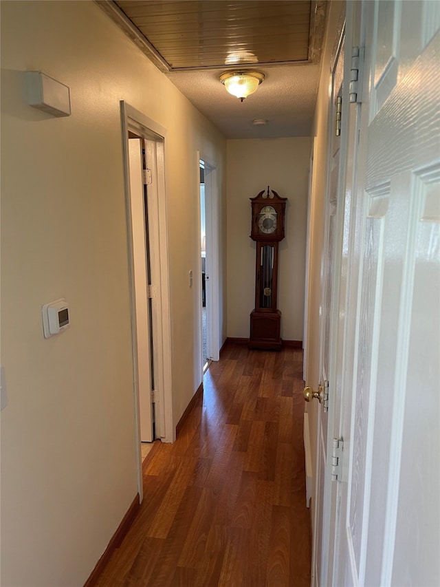 hall featuring baseboards and wood finished floors