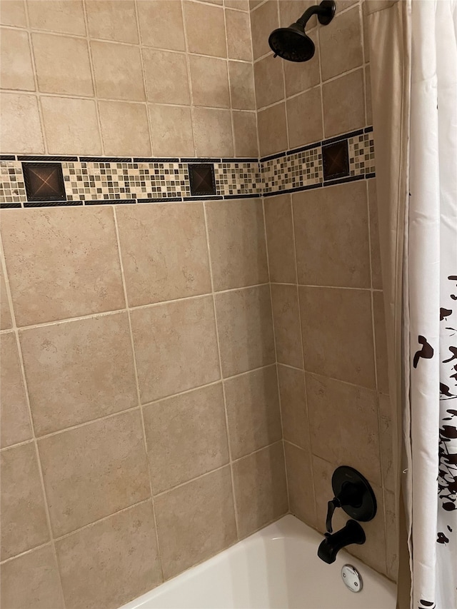 bathroom featuring shower / bathtub combination with curtain