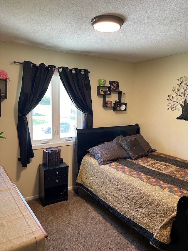 bedroom featuring carpet floors and a textured ceiling
