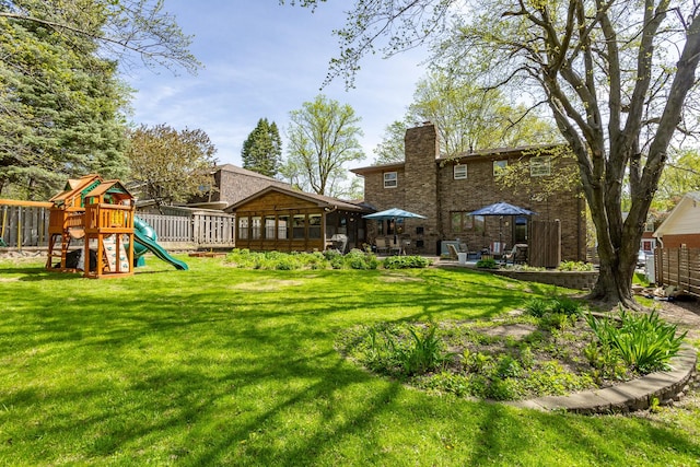 view of yard featuring fence and a playground