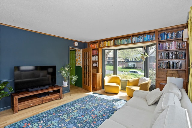 living room with a textured ceiling and wood finished floors