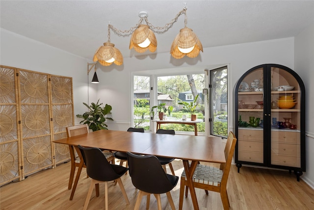 dining space featuring light wood-type flooring