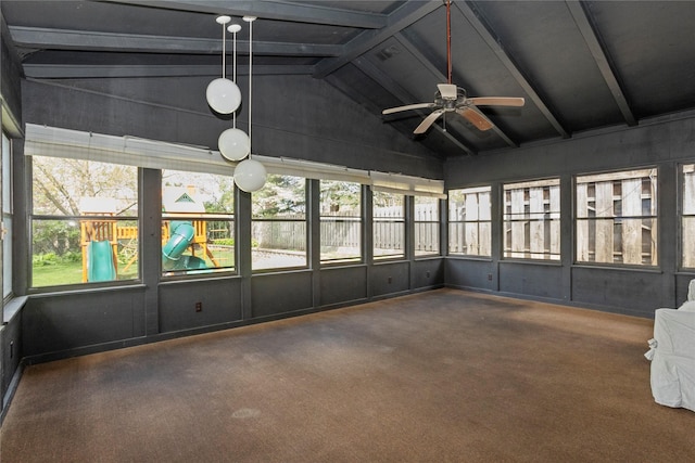 unfurnished sunroom featuring beamed ceiling and a ceiling fan