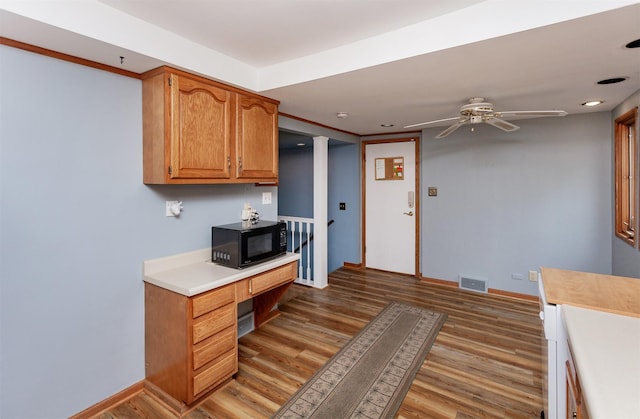 kitchen with ceiling fan, visible vents, black microwave, light countertops, and light wood finished floors