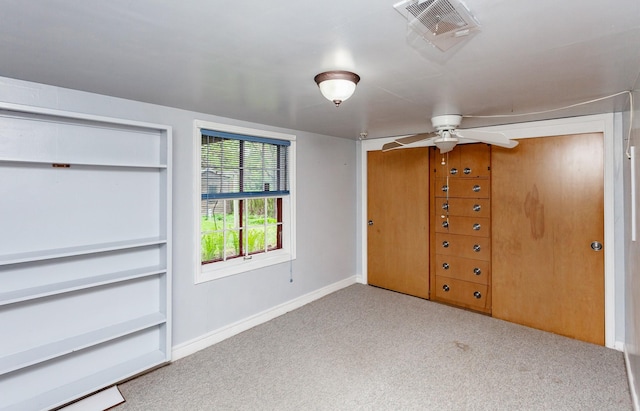 unfurnished bedroom featuring carpet floors, baseboards, and visible vents