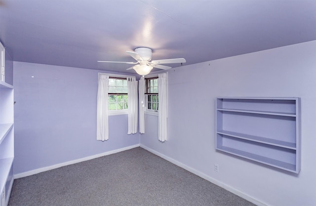 carpeted spare room with baseboards and ceiling fan