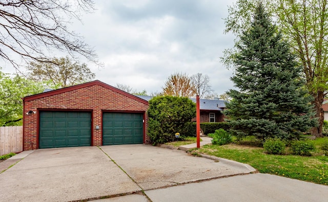 detached garage featuring fence