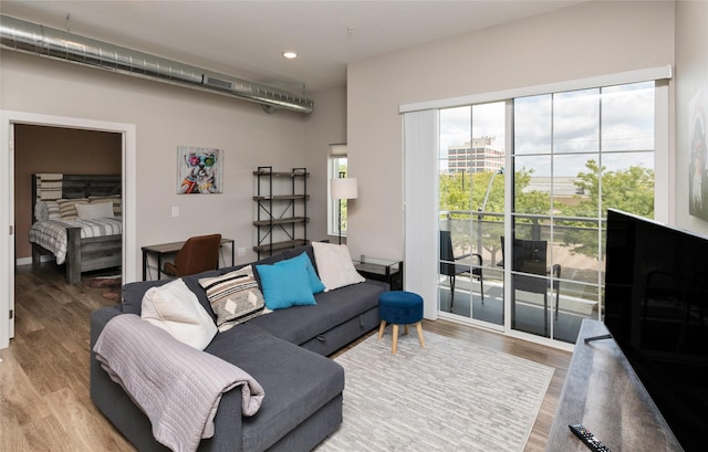 living room with recessed lighting and wood finished floors