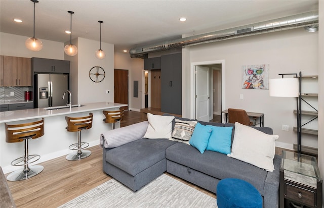 living room featuring visible vents, recessed lighting, and light wood-style flooring