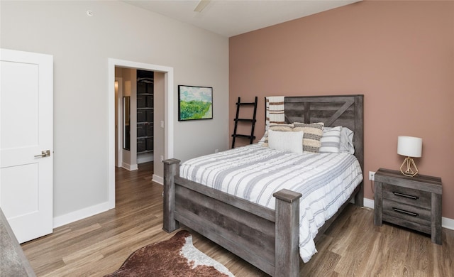 bedroom with baseboards and wood finished floors