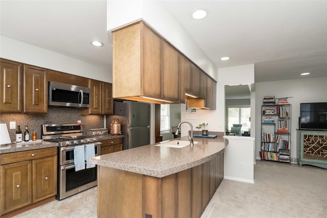 1233 24th St, West Des Moines, IA 50266 - kitchen with stainless steel appliances, a sink, backsplash, recessed lighting, and a peninsula