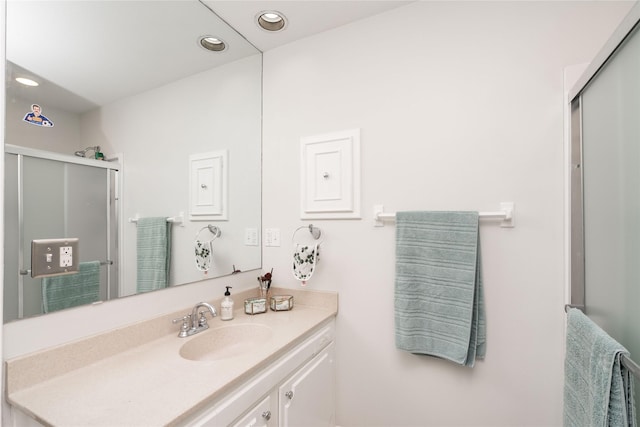 full bathroom with recessed lighting, a shower stall, and vanity