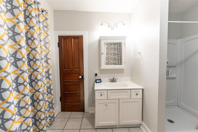 bathroom with baseboards, tile patterned flooring, and a shower stall