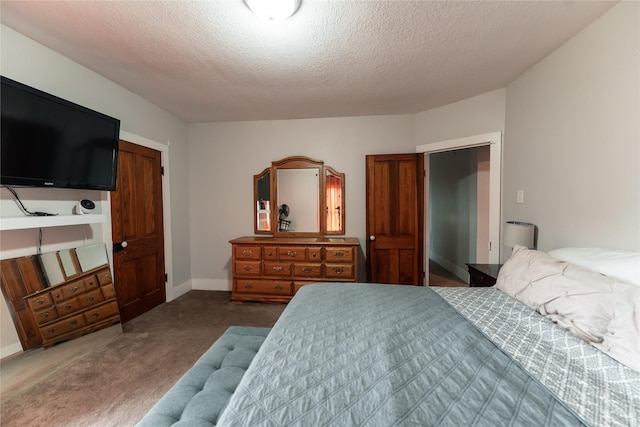 bedroom featuring a textured ceiling and carpet