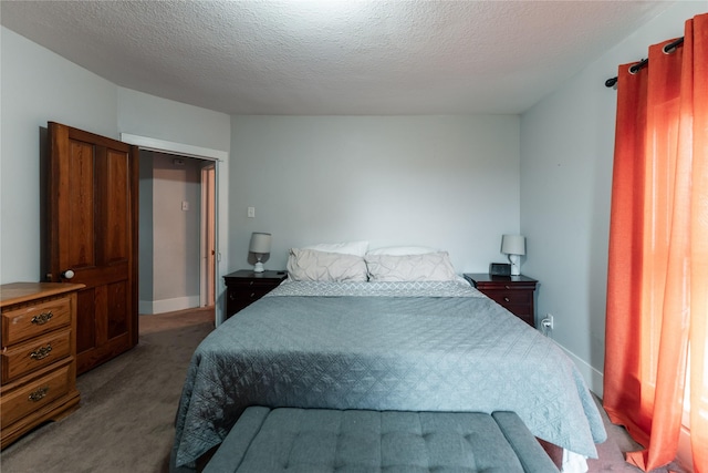 carpeted bedroom with baseboards and a textured ceiling