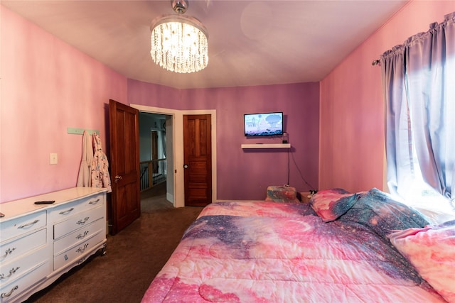 bedroom featuring dark colored carpet and an inviting chandelier