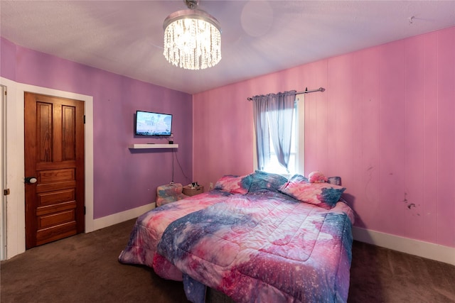 carpeted bedroom with baseboards and a chandelier