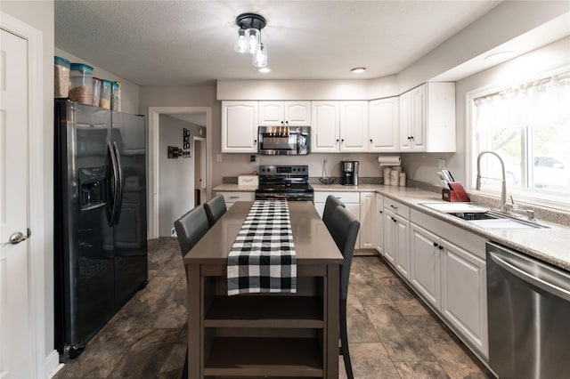 kitchen featuring open shelves, a sink, light countertops, stainless steel appliances, and white cabinetry