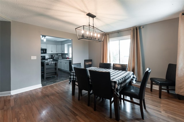 dining room with dark wood-type flooring, baseboards, and a wealth of natural light