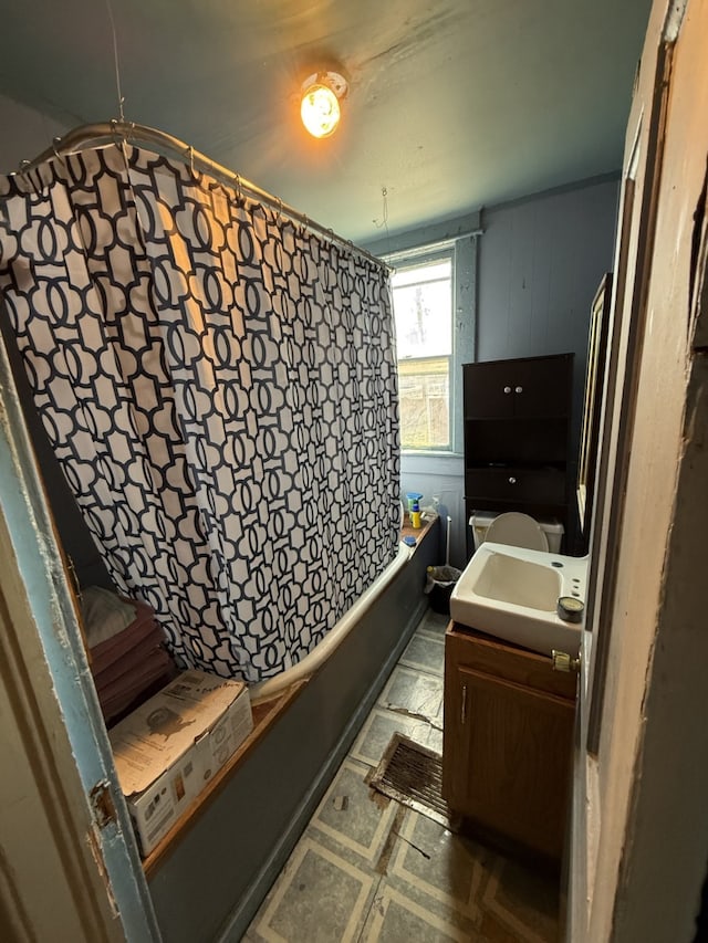 bathroom featuring tile patterned floors, toilet, shower / tub combo, and vanity