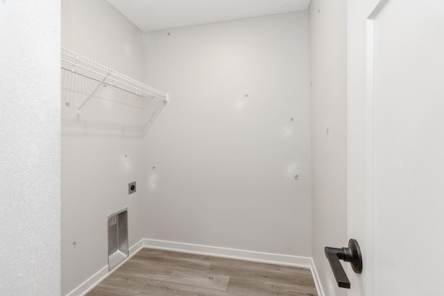 washroom featuring baseboards, laundry area, electric dryer hookup, and wood finished floors