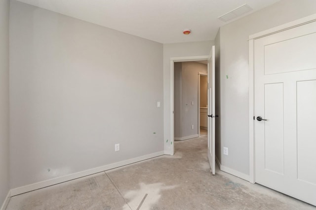 spare room with baseboards and visible vents