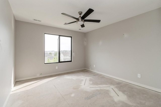 spare room featuring baseboards, a ceiling fan, and visible vents