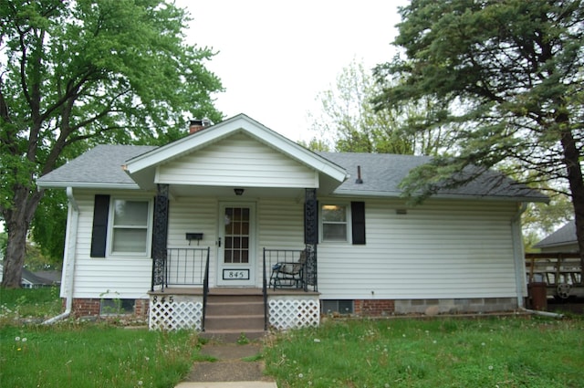bungalow-style house with a porch and a chimney