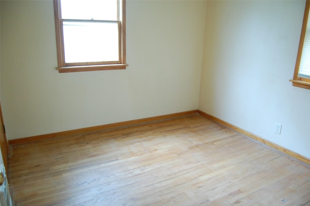 empty room featuring light wood-style floors and baseboards