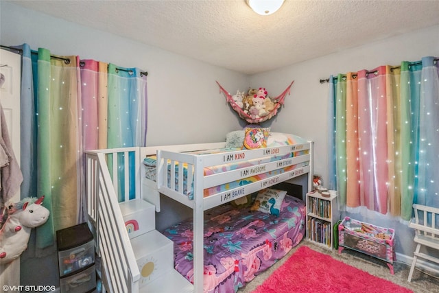 carpeted bedroom featuring a textured ceiling