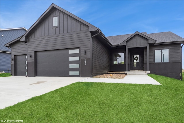 view of front of house with board and batten siding, an attached garage, concrete driveway, and a front yard