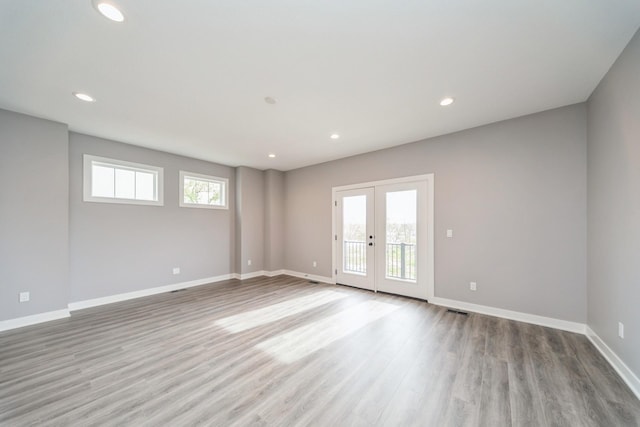 spare room featuring recessed lighting, baseboards, french doors, and wood finished floors