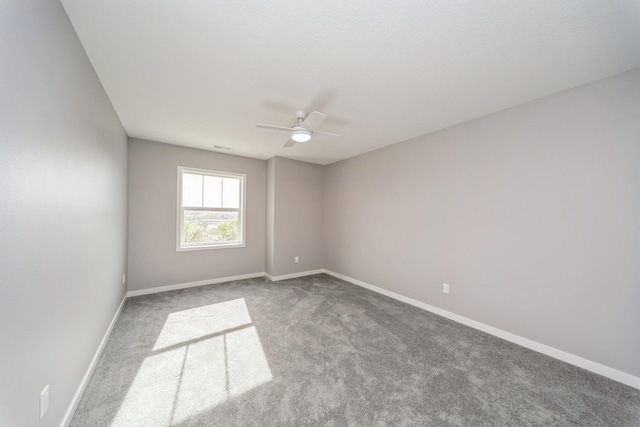 carpeted empty room with baseboards and ceiling fan