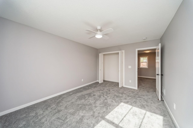 unfurnished bedroom featuring carpet flooring, baseboards, and ceiling fan