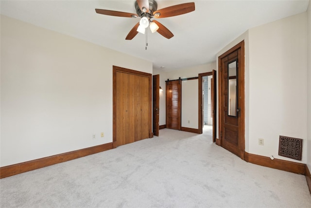 empty room featuring visible vents, baseboards, ceiling fan, and light carpet