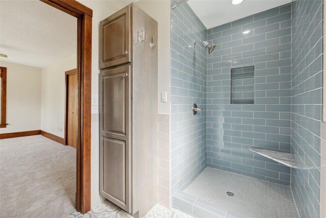 218 E Howard St, Colfax, IA 50054 - bathroom with baseboards and a tile shower