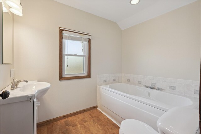 218 E Howard St, Colfax, IA 50054 - full bath with vanity, toilet, baseboards, wood finished floors, and a bath