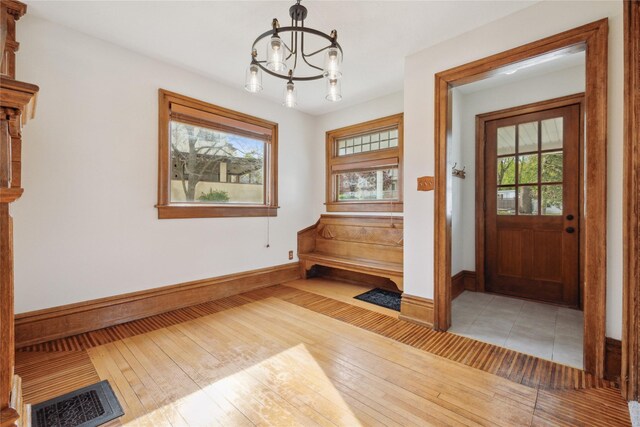 218 E Howard St, Colfax, IA 50054 - interior space with an inviting chandelier, a wealth of natural light, light wood-style floors, and visible vents