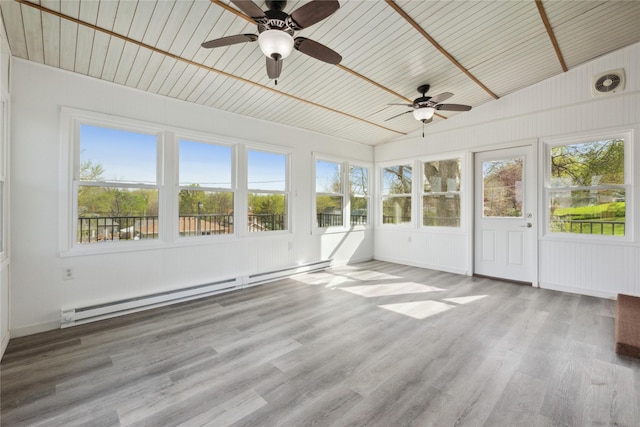 unfurnished sunroom with ceiling fan, wood finished floors, and a baseboard radiator