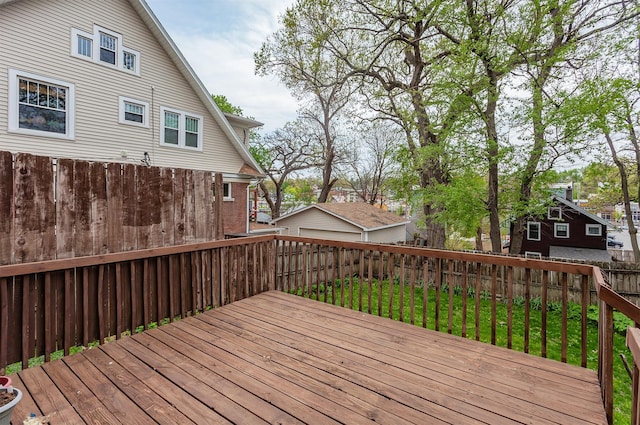 wooden deck featuring a fenced backyard and a lawn