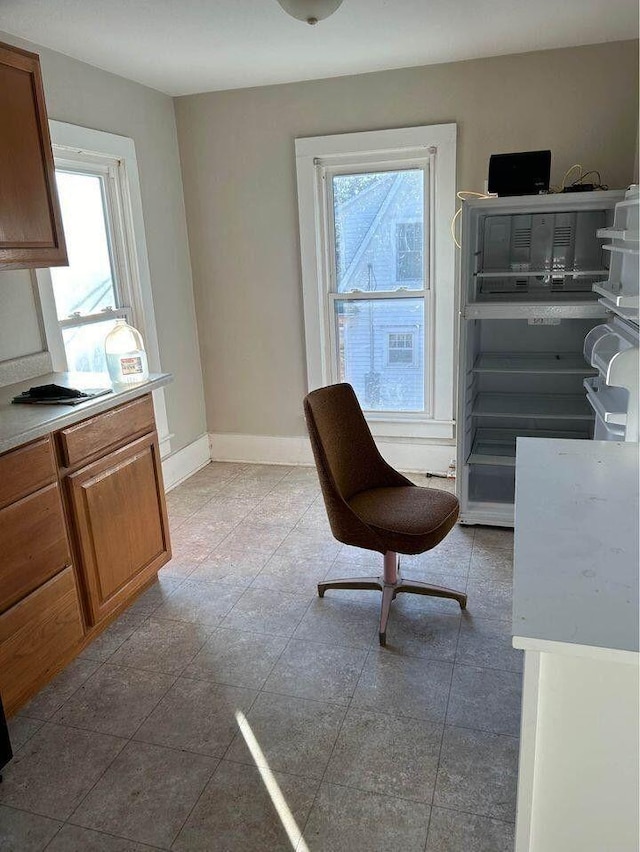 living area featuring baseboards and tile patterned floors
