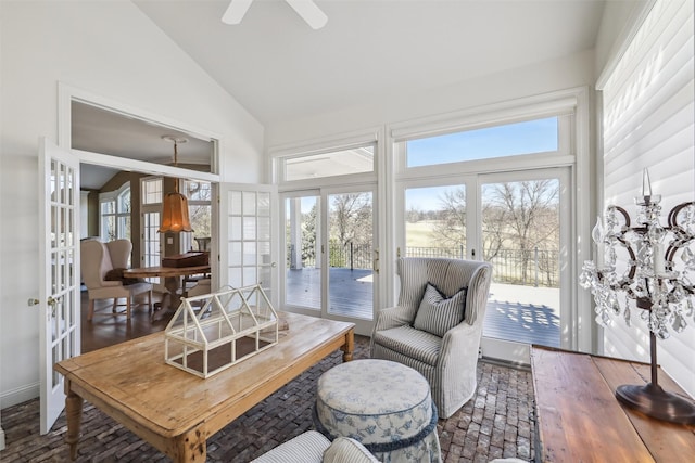 sunroom with a healthy amount of sunlight, high vaulted ceiling, and french doors