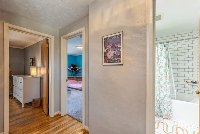 hall with baseboards and light wood-style flooring